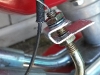 metal bracket with secured onto throttle cable