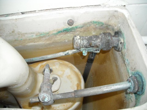 close-up of old ball-cock and valve